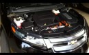 2011 Chevrolet Volt with hood open, showing range extender engine and Voltec drive