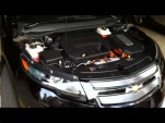 2011 Chevrolet Volt with hood open, showing range extender engine and Voltec drive