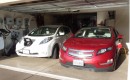 2011 Nissan Leaf and 2011 Chevy Volt, with charging station visible; photo by George Parrott