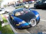 A golden retriever sits in the passenger seat of a Bugatti Veyron in L.A. 