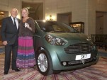 Sir Stirling Moss and his new Aston Martin Cygnet
