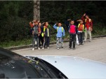 Chinese children salute cars [Du Bin for The New York Times]