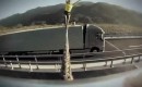 Faith Dickey walks a line strung between two moving Volvo trucks