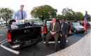 GM representatives with GMC Sierras and supplies bound for Haiti