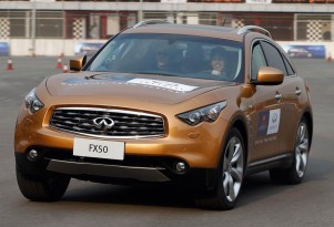 Sebastian Vettel at a track with the Infiniti G37 and FX50 