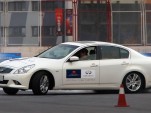 Sebastian Vettel at a track with the Infiniti G37 and FX50 