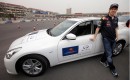 Sebastian Vettel at a track with the Infiniti G37 and FX50 