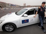 Sebastian Vettel at a track with the Infiniti G37 and FX50 