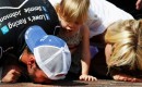 Jimmie, Genevieve Marie and Chandra Johnson kiss Indy's bricks - NASCAR photo