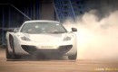 Lewis Hamilton uses a McLaren MP4-12C to sign his name 