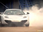 Lewis Hamilton uses a McLaren MP4-12C to sign his name 