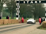Lord March pilots the Aston Martin Vanquish up Goodwood Hill