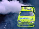 Paul Menard does a burnout in the #27 car after winning the Brickyard 400. Image via NASCAR.