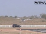 Photo of a light plane about to crash into a moving vehicle while attempting to land