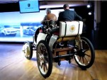 Porsche's re-created 1900 Semper Vivus hybrid drives across the floor at media event, April 2011