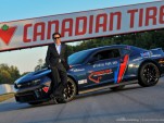 Ron Fellows poses with the Camaro ZL1 pace car to be auctioned