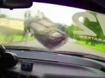 Russian race car somersaults after contact with low wall