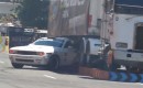 Samuel Hübinette drifts his Dodge Challenger under a semi truck