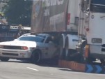 Samuel Hübinette drifts his Dodge Challenger under a semi truck