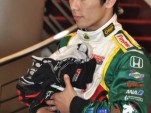 Takuma Sato with driver gloves collected for tsunami relief - Anne Proffit photo