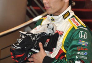 Takuma Sato with driver gloves collected for tsunami relief - Anne Proffit photo