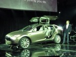 Tesla CEO Elon Musk, demonstrating the Model X third-row seat and falcon doors