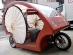 Three-seat, three-wheeled electric vehicle in traditional Japanese style, photo by Kyodo Photo.