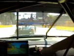 Tommy Milner closing on  a Le Mans Prototype in Baltimore's turn one