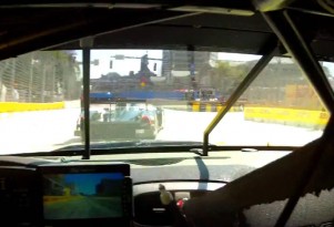 Tommy Milner closing on  a Le Mans Prototype in Baltimore's turn one