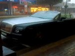 Topless Rolls-Royce Phantom Drophead Coupe in downpour
