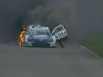 Tuka Rocha rolls out of his burning race car is it continues down the track.
