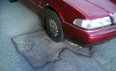 Volvo on pothole - flickr user comedy_nose