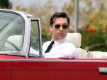 Actor Jon Hamm in a 1964 Chrysler Imperial Convertible during the filming of Mad Men
