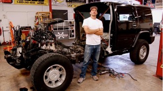 Artist Jeremy Dean with half a Hummer H2 for his work, "Back to the Futurama," January 2010