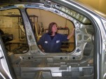 GM corrosion engineer Christa Cooper inspects a Cruze body shell for rust. Image: © GM Corp.