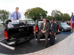 GM representatives with GMC Sierras and supplies bound for Haiti