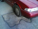 Volvo on pothole - flickr user comedy_nose